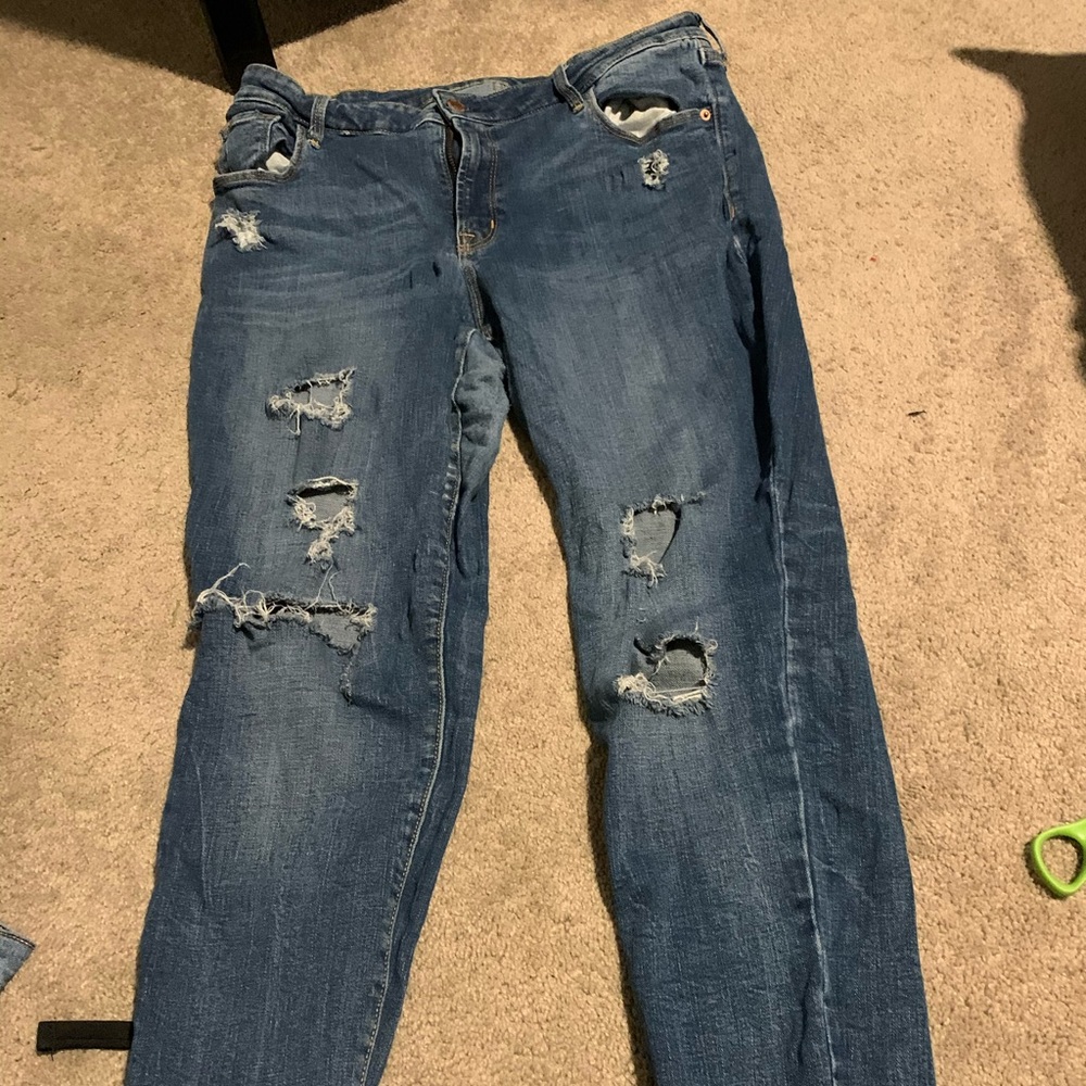 Selling a pair of Jeans with holes down the leg.
